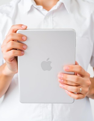 A person holds a tablet in their hands