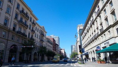 A sunny day in a city street with tall buildings