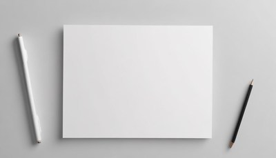 A blank sheet of paper with a pen and pencil