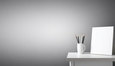 A blank canvas sits on a white table, ready to be painted