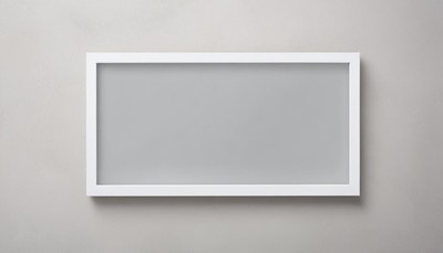 A white frame hangs on a gray wall