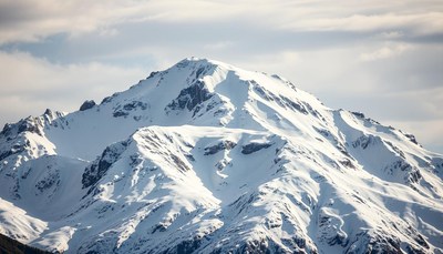 A snowy mountain range on a bright day