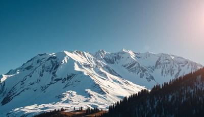Snowy mountains rise against a clear blue sky