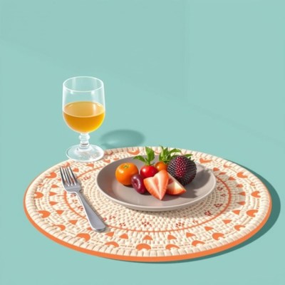 A glass of juice and fruit sit on a placemat