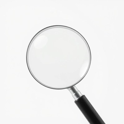 A magnifying glass rests on a white surface