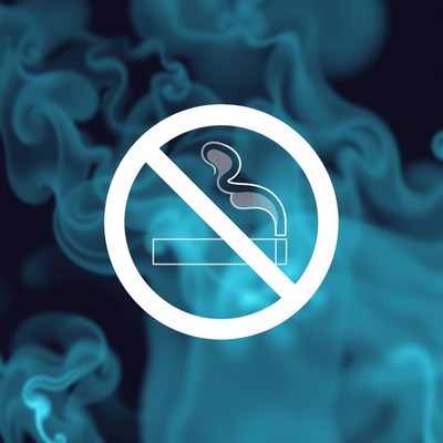 A no smoking sign against a blue smoke background