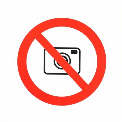 Red circle with diagonal line: no photography