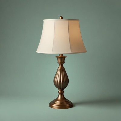 Bronze lamp with white shade on teal surface