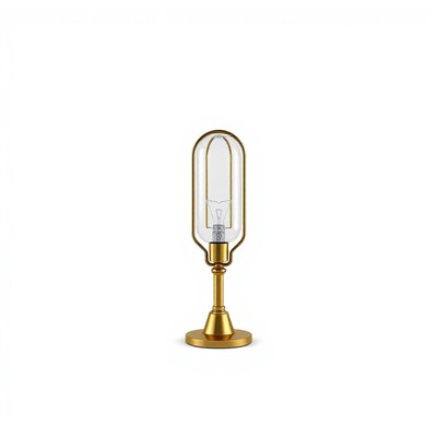 A gold table lamp with a clear glass shade