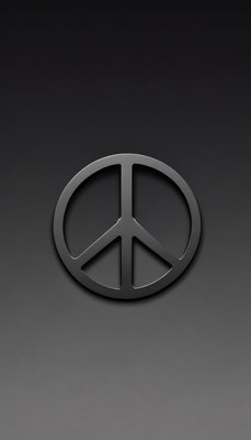 A peace sign sits on a black surface