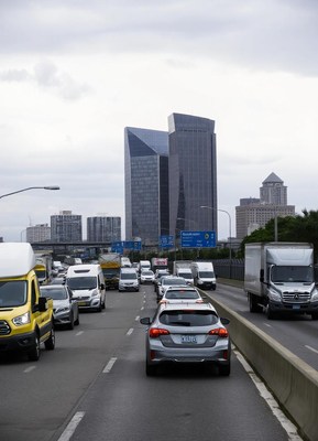 Traffic on a city highway with tall buildings