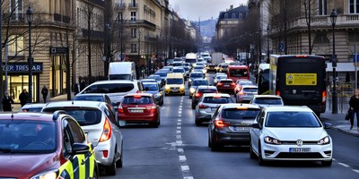 Cars drive through paris during rush hour