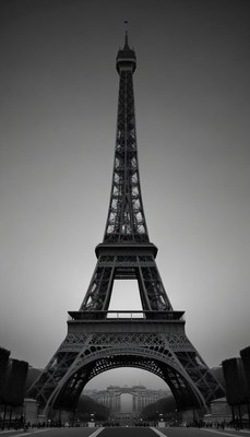 The eiffel tower stands tall against a gray sky