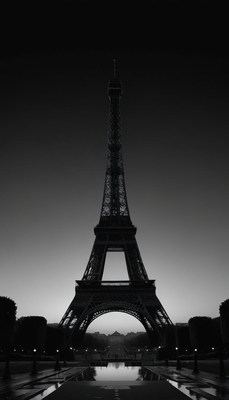 The eiffel tower stands tall against the evening sky