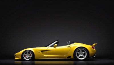 Yellow convertible sports car on black background