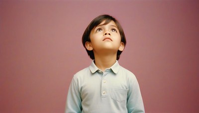 A young boy looks up in wonder