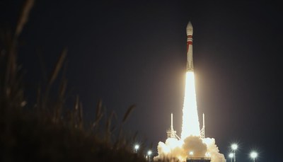 A rocket launches into the night sky