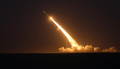 A rocket launches into the night sky