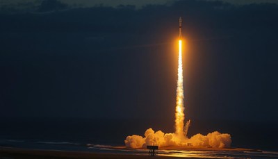A rocket launches into the night sky