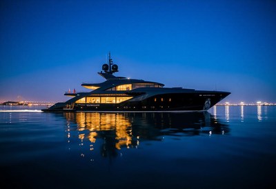 A large yacht sits on the water at dusk