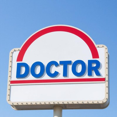 A doctor sign against a blue sky