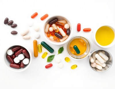 Various supplements in bowls on a white background