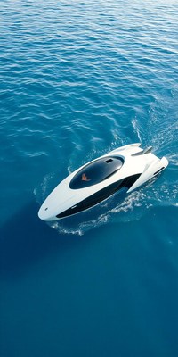 A white boat with a clear canopy glides across the ocean