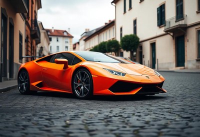 An orange sports car parked on a cobblestone street