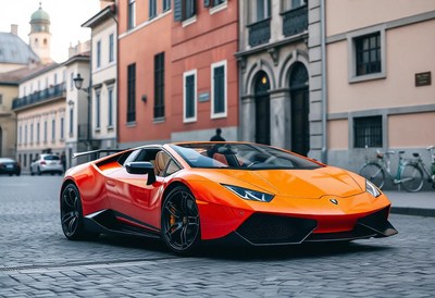An orange sports car parked on a city street