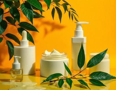 White skincare bottles with green leaves