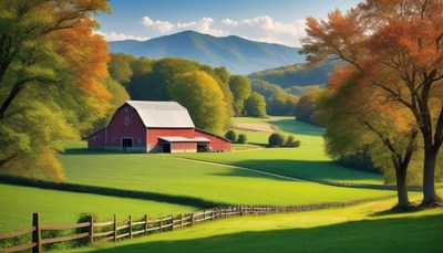 A red barn sits on a green hill in the countryside