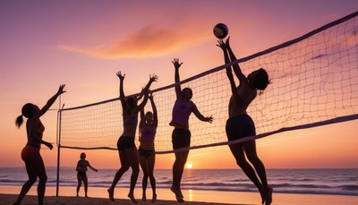 People play volleyball at sunset on the beach