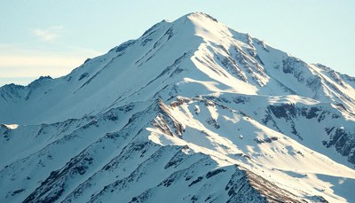 A snow-capped mountain peak in the early morning light