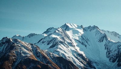 Snow-capped mountains rise against a blue sky
