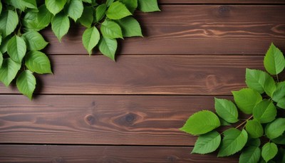 Green leaves on a brown wooden surface