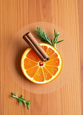 Orange slice with cinnamon and rosemary on wood
