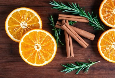 Orange slices, cinnamon, and rosemary on wood