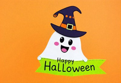 A cheerful ghost in a witch hat with a halloween sign