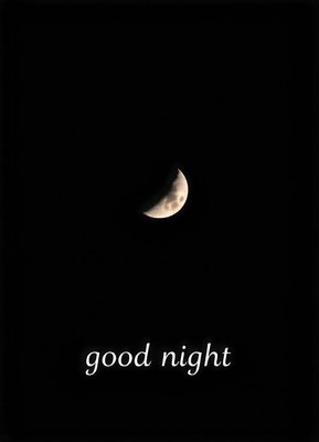 A crescent moon shines in the night sky