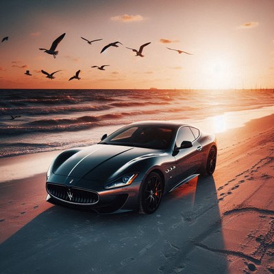 A black sports car sits on the beach at sunset