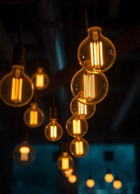 Warm lights hang from the ceiling in a dimly lit room