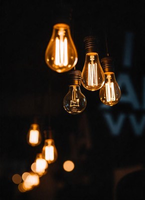 Edison bulbs hang in a dark room