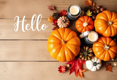 Hello, fall! pumpkins and candles on a wooden table