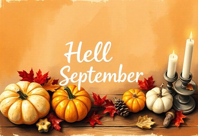Hello september, pumpkins and candles on a wooden table