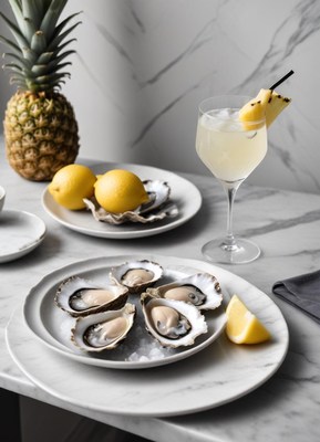 Oysters, lemon wedge, and a drink with pineapple