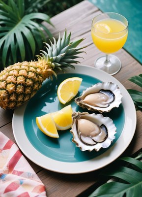 Fresh oysters on a plate with lemon wedges and a pineapple