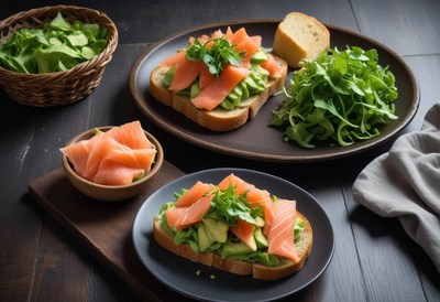 Two salmon avocado toasts with a side of greens