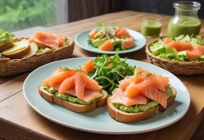 Two salmon and avocado toasts with salad on a blue plate