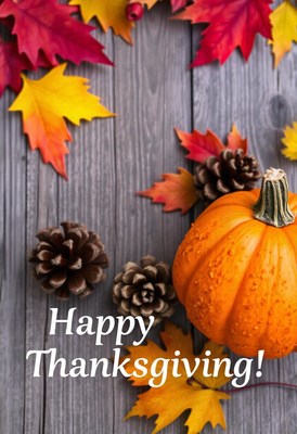 A whole orange pumpkin sits on a gray wooden table