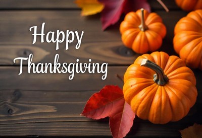 Happy thanksgiving with pumpkins and leaves on a wood table